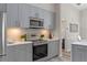 Updated kitchen featuring stainless appliances, gray cabinets, and stone countertops at 14750 Hartford Run Dr, Orlando, FL 32828