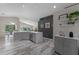 Open concept kitchen with stainless appliances, gray cabinets, and stone countertops at 14750 Hartford Run Dr, Orlando, FL 32828