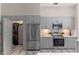 Bright kitchen features gray cabinets, stainless steel appliances, and a laundry closet at 14750 Hartford Run Dr, Orlando, FL 32828