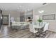 Modern kitchen with a large island, breakfast bar, stainless steel appliances, and adjacent dining area at 14750 Hartford Run Dr, Orlando, FL 32828