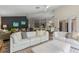 Open-concept living room with sleek floors, modern furniture, neutral color palette, and seamless transition to kitchen at 14750 Hartford Run Dr, Orlando, FL 32828