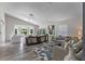 Bright living room with hardwood floors, vaulted ceiling, contemporary decor, and natural light from large windows at 14750 Hartford Run Dr, Orlando, FL 32828