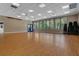 Large meeting room with wood flooring, large windows overlooking community landscaping, and stackable chairs at 14750 Hartford Run Dr, Orlando, FL 32828