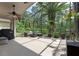 Relaxing screened-in patio with furniture and palm trees overlooking a private backyard at 14750 Hartford Run Dr, Orlando, FL 32828
