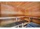 Inviting cedar sauna with wooden benches and a heater, perfect for relaxation and wellness at 14750 Hartford Run Dr, Orlando, FL 32828