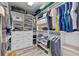 Spacious walk-in closet featuring built-in shelving, drawers, and ample hanging space for organized storage at 14750 Hartford Run Dr, Orlando, FL 32828