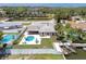 An aerial view of the backyard featuring an in-ground pool, outdoor kitchen, and waterfront canal at 151 Sea Isle Cir, South Daytona, FL 32119