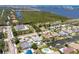 A bird's eye view showing a waterfront home with a pool and canal, surrounded by lush greenery at 151 Sea Isle Cir, South Daytona, FL 32119