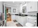 Light bathroom with tile floors, mosaic backsplash and double sink vanity at 151 Sea Isle Cir, South Daytona, FL 32119