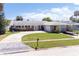 Classic brick home with an attached garage, long driveway, and lush green front yard at 151 Sea Isle Cir, South Daytona, FL 32119