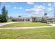 Charming brick home boasts a well-maintained lawn, curved driveway, and a basketball hoop at 151 Sea Isle Cir, South Daytona, FL 32119