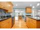 Modern kitchen with sleek black countertops, stainless steel appliances, and light wood cabinets at 151 Sea Isle Cir, South Daytona, FL 32119