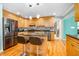 Bright kitchen features stainless steel appliances, an island with seating, and light wood cabinets at 151 Sea Isle Cir, South Daytona, FL 32119