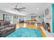 Bright living room with a fireplace, pool table, and sliding doors leading to the outside at 151 Sea Isle Cir, South Daytona, FL 32119