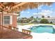 Outdoor living area featuring a tiki bar, seating and refreshing swimming pool at 151 Sea Isle Cir, South Daytona, FL 32119
