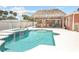 Sparkling in-ground pool features a crisp white surround with blue tile accents and a thatched roof cabana at 151 Sea Isle Cir, South Daytona, FL 32119