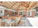 Tropical tiki bar with seating creates a perfect outdoor entertaining space at 151 Sea Isle Cir, South Daytona, FL 32119