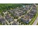 Community aerial view featuring beautiful homes, mature trees, and a scenic neighborhood pond at 1516 Resolute St, Celebration, FL 34747