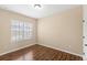 Bedroom featuring hardwood floors, base trim, and a window that provides plenty of natural light at 1516 Resolute St, Celebration, FL 34747