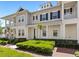 Charming townhome featuring a covered porch, neat landscaping, and a welcoming facade at 1516 Resolute St, Celebration, FL 34747