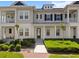 Inviting townhome with a well manicured lawn, covered entry, and stylish architectural details at 1516 Resolute St, Celebration, FL 34747