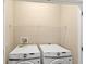 Bright laundry room featuring a side-by-side washer and dryer and overhead storage shelf at 1516 Resolute St, Celebration, FL 34747