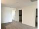Neutral-toned bedroom with carpet flooring and access to bathroom and laundry room at 16284 Hamlin View St, Winter Garden, FL 34787
