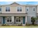 Charming townhome featuring a teal door, stone accents, and light neutral siding at 16284 Hamlin View St, Winter Garden, FL 34787