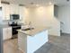 Bright kitchen with white cabinets, stainless appliances, and a large center island at 16284 Hamlin View St, Winter Garden, FL 34787