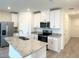 Modern kitchen with white cabinets, stainless steel appliances, and granite countertops at 16284 Hamlin View St, Winter Garden, FL 34787