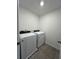 Dedicated laundry room with modern washer and dryer units on tile flooring at 16284 Hamlin View St, Winter Garden, FL 34787