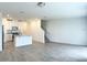 Open-concept living space with tile flooring and ample natural light, flowing into the kitchen at 16284 Hamlin View St, Winter Garden, FL 34787