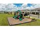 Community playground with slides and green space, offering a fun recreational area at 16284 Hamlin View St, Winter Garden, FL 34787