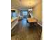 Open-concept dining area with modern lighting, seamlessly connecting to the living room and kitchen at 16290 Hamlin View St, Winter Garden, FL 34787