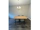 Minimalist dining area showcasing a modern table and chair set illuminated by an elegant chandelier at 16290 Hamlin View St, Winter Garden, FL 34787
