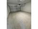 Empty two car garage with concrete floors and white walls at 16290 Hamlin View St, Winter Garden, FL 34787