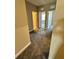 A carpeted hallway leads to multiple rooms with bright, natural light at 16290 Hamlin View St, Winter Garden, FL 34787