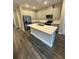 Modern kitchen featuring a center island with stainless steel appliances and ample cabinet storage at 16290 Hamlin View St, Winter Garden, FL 34787