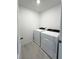 A well-lit laundry room featuring a modern washer and dryer set at 16290 Hamlin View St, Winter Garden, FL 34787