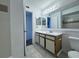 This bright bathroom offers a large mirror, vanity with storage, and tiled floor for easy maintenance at 1908 Lake Atriums Cir # 20, Orlando, FL 32839