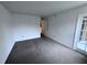 A carpeted bedroom boasts neutral walls and a door leading to the outside at 1908 Lake Atriums Cir # 20, Orlando, FL 32839