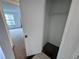 This walk-in closet features neutral carpet, white walls, and shelving for organization at 1908 Lake Atriums Cir # 20, Orlando, FL 32839