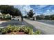 Community entrance with a security gate, ample parking, and landscaping at 1908 Lake Atriums Cir # 20, Orlando, FL 32839
