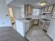 Bright kitchen offers white countertops and appliances, complemented by tile flooring at 1908 Lake Atriums Cir # 20, Orlando, FL 32839
