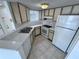 Well-lit kitchen features a double sink, white countertops, and matching appliances at 1908 Lake Atriums Cir # 20, Orlando, FL 32839