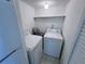 Dedicated laundry room with washer, dryer, and shelving for extra storage at 1908 Lake Atriums Cir # 20, Orlando, FL 32839