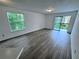 Spacious living room with a large window, sliding glass doors, and laminate flooring at 1908 Lake Atriums Cir # 20, Orlando, FL 32839