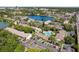 An aerial view of a lakeside community with mature trees, ample parking, and a community pool at 200 Maitland Ave # 28, Altamonte Springs, FL 32701