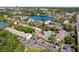 Community aerial view with lake, complex, pool and surrounding trees with parking at 200 Maitland Ave # 28, Altamonte Springs, FL 32701