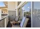 Relaxing balcony with chairs, offering a view of the building's architecture and green surroundings at 200 Maitland Ave # 28, Altamonte Springs, FL 32701